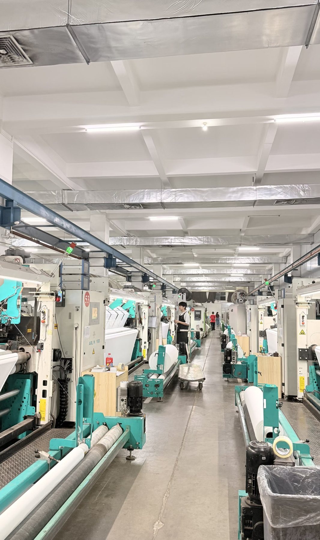 Rows of computerized flat knitting machines in our Puyuan production floor