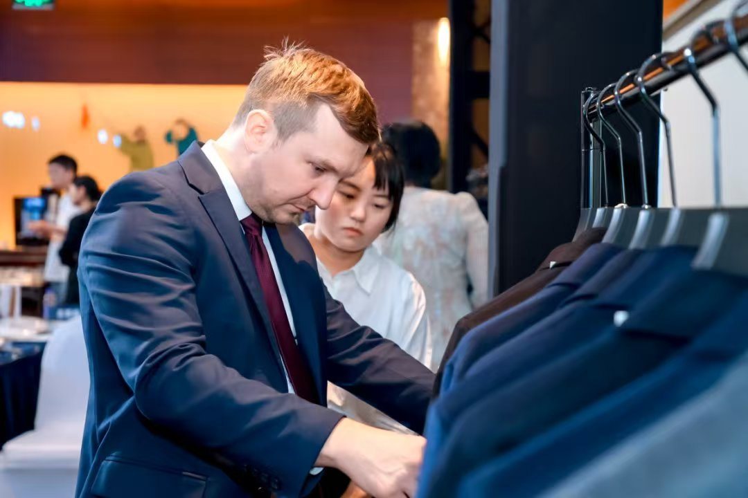 Buyer reviewing knitwear at an event